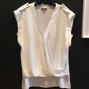 High low white top with brass detail.